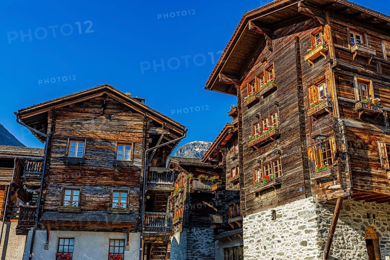 Old wooden houses in log construction, decorated with flowers, historic village centre, Grimentz, Val d'Anniviers, Valais Alps, Canton Valais, Switzerland
