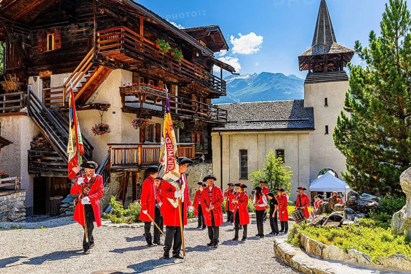 Pipers and drummers line up for the Corpus Christi procession, behind the church of Saint Theodul, historic town centre, Grimentz, Val d'Anniviers, Valais Alps, Canton Valais, Switzerland