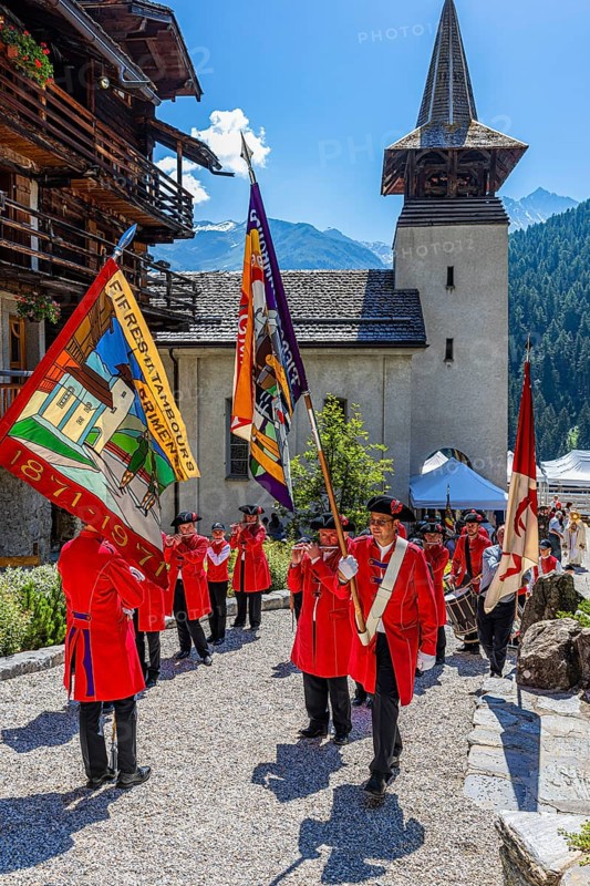 Pipers and drummers line up for the Corpus Christi procession, behind the church of Saint Theodul, historic town centre, Grimentz, Val d'Anniviers, Valais Alps, Canton Valais, Switzerland