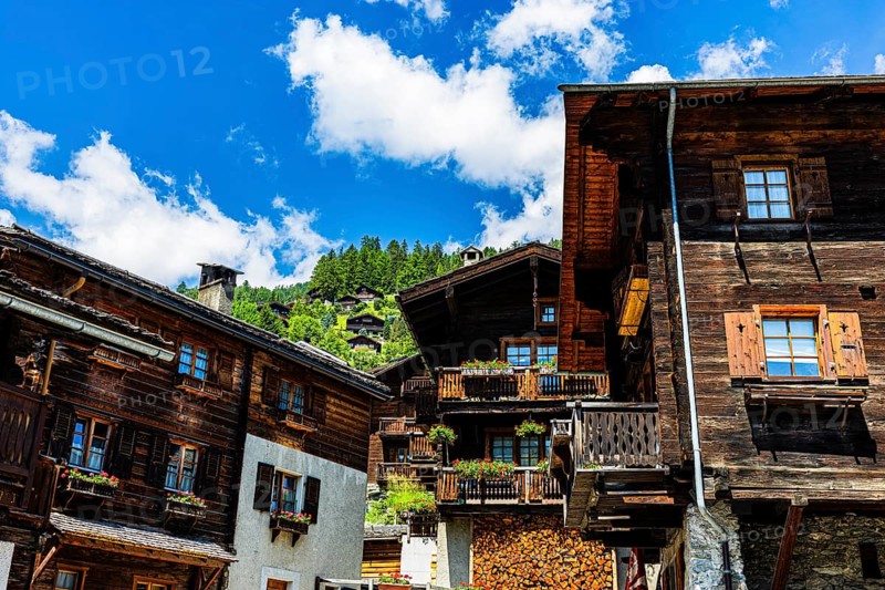 Old wooden houses in log construction, decorated with flowers, historic village centre, Grimentz, Val d'Anniviers, Valais Alps, Canton Valais, Switzerland