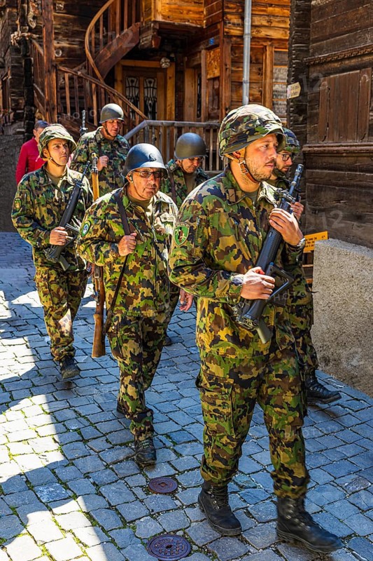 Soldiers from the local heritage society accompany the Corpus Christi procession, historic town centre, Grimentz, Val d'Anniviers, Valais Alps, Canton Valais, Switzerland
