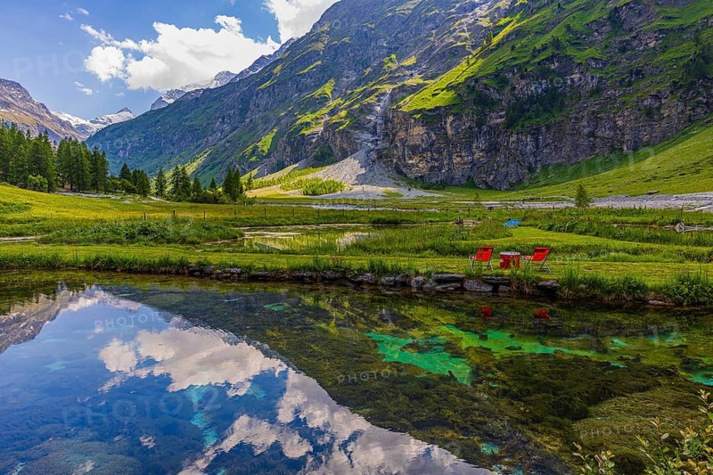 Mountains and clouds reflected in a pond, near Relais Tzoucdana, Zinal, Val d'Anniviers, Valais Alps, Canton Valais, Switzerland