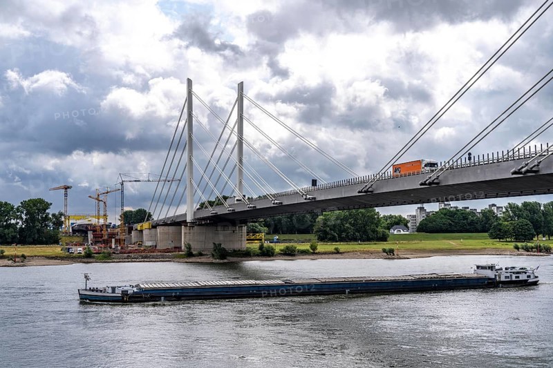 Rhine bridge Duisburg-Neuenkamp, the A40 motorway, start of construction of the second bridge, bridge piers and the first bridge segment are erected on the Neuenkamp side of the Rhine, cargo ship on the Rhine, North Rhine-Westphalia, Germany