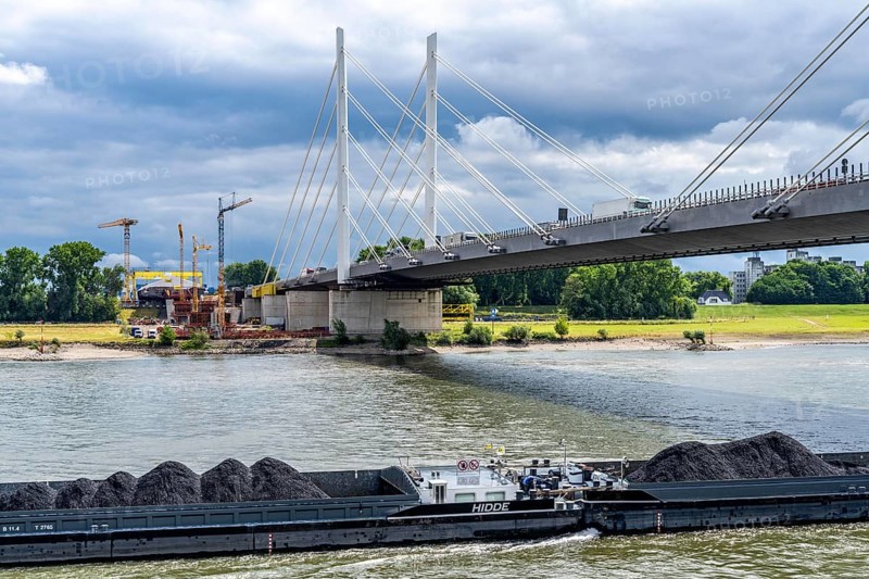 Rhine bridge Duisburg-Neuenkamp, the A40 motorway, start of construction of the second bridge, bridge piers and the first bridge segment are erected on the Neuenkamp side of the Rhine, cargo ship on the Rhine, with coal for a power station in Karlsruhe, North Rhine-Westphalia, Germany