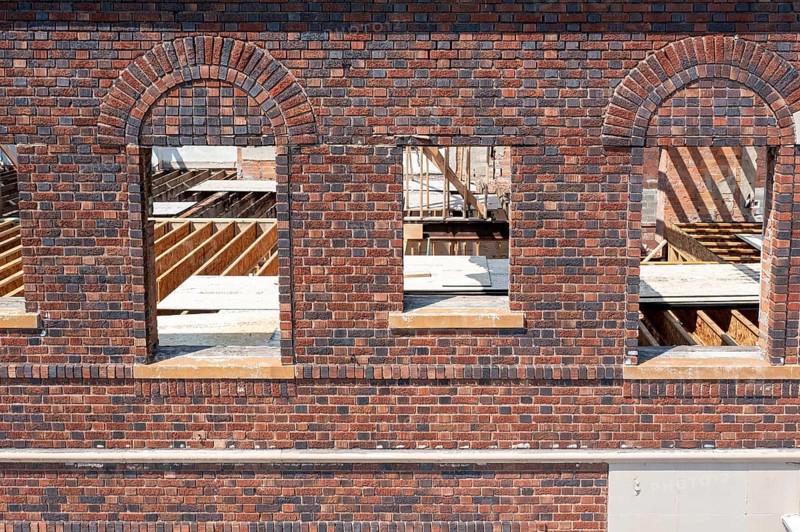 Detroit, Michigan - Workers rehab a long-vacant and crumbling commercial building in the Morningside neighborhood. The project, called Ultreia, will contain first floor commercial space and apartments above