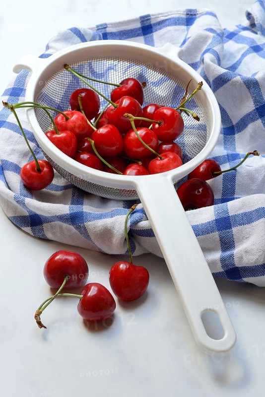 Sweet cherries in sieve, Prunus avium, bird cherry
