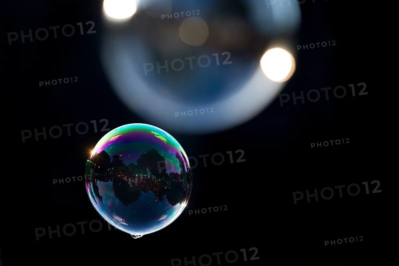 Two shimmering and floating soap bubbles against a black background, Recklinghausen, North Rhine-Westphalia, Germany