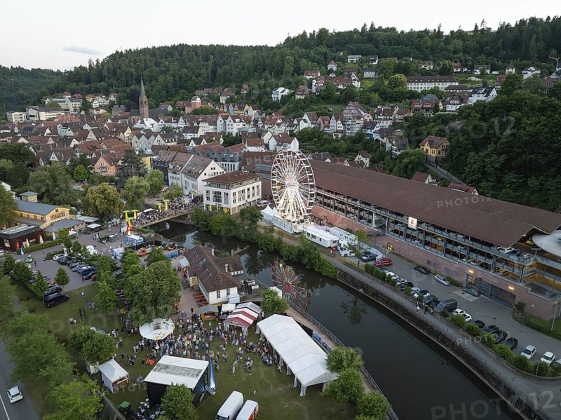 Urban festival with Ferris wheel and event tents next to a river, 950 years of Calw, Germany