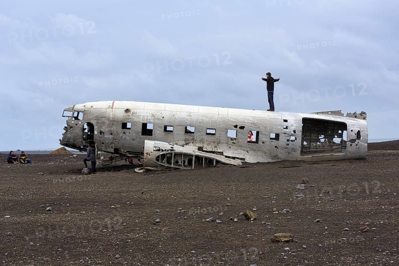 Tourist on aircraft wreckage, US Navy Douglas DC-3 transport plane, Sander, volcanic landscape, Sólheimasandur, Solheimasandur, near ring road, Suðurland, Sudurland, South Iceland, Iceland