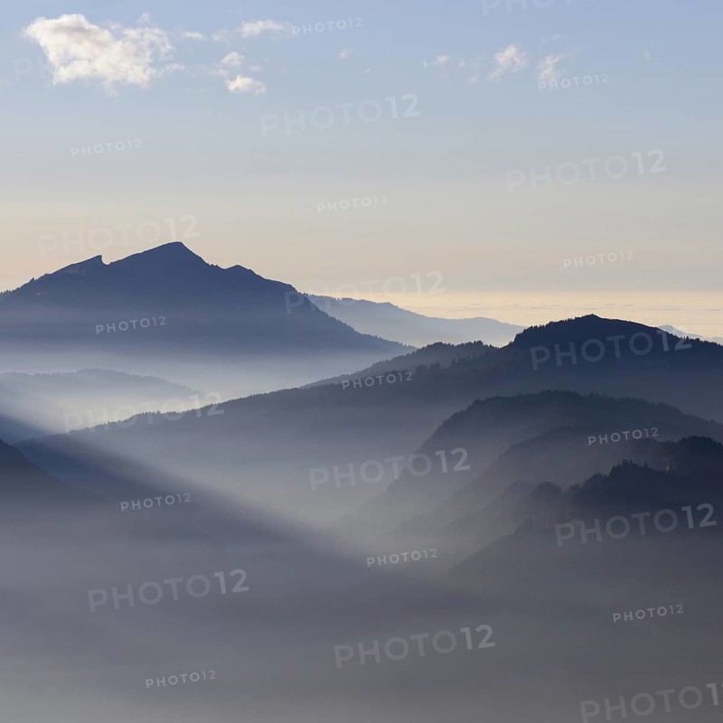 Mountain silhouettes... Alpine peaks and mountain ranges in the Bavarian Alps, light fog rises from the valleys, which creates an idyllic atmosphere in the light of the low sun, romantic view from Oberstdorf towards Kleinwalsertal, local nature, Bavaria, Allgäu, Allgäu Alps, Bavarian, Germany, Western Europe
