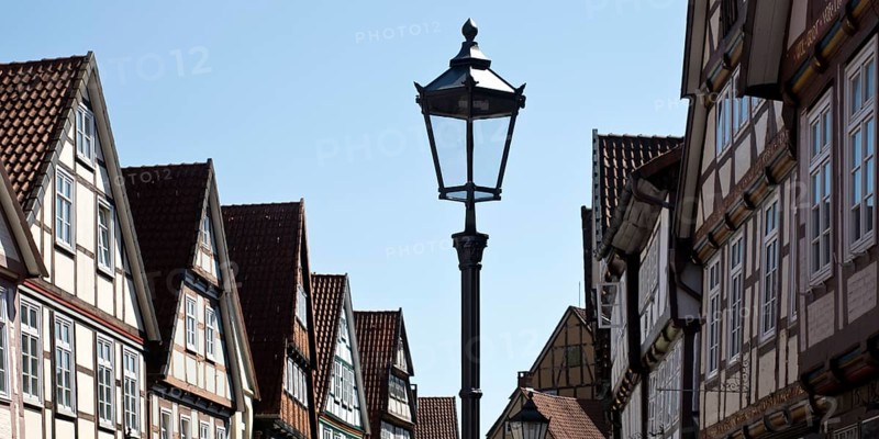 Street with half-timbered houses and historic street lamp in the old town centre, Celle, Lower Saxony, Germany