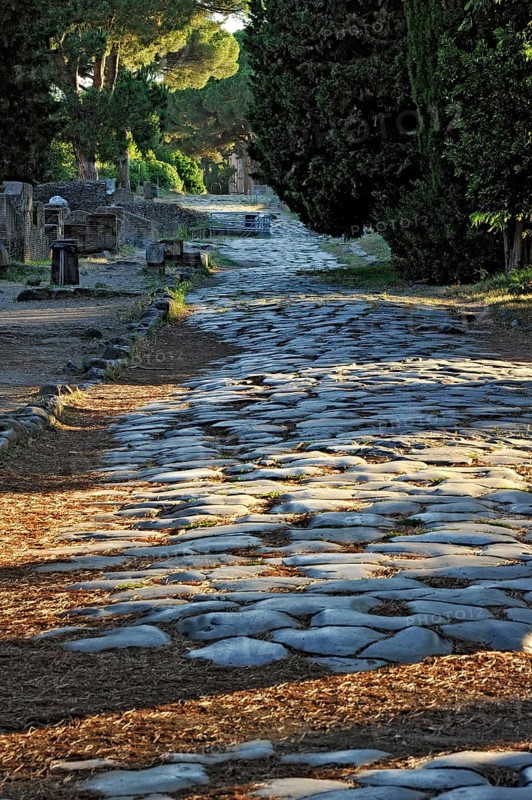 Ancient pavement of the main street Decumano Massimo, large paving stones, remains, ruins, ancient port city of Rome, excavation site Archaeological Park Ostia Antica, metropolitan city of Rome, Lazio, Italy