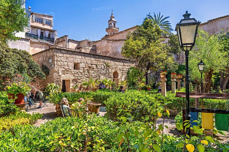 Lush green ornamental garden with visitors at the Arab Baths a historic site in city of Palma a sunny summer day, Arab Baths, Palma de Mallorca, Mallorca, Spain