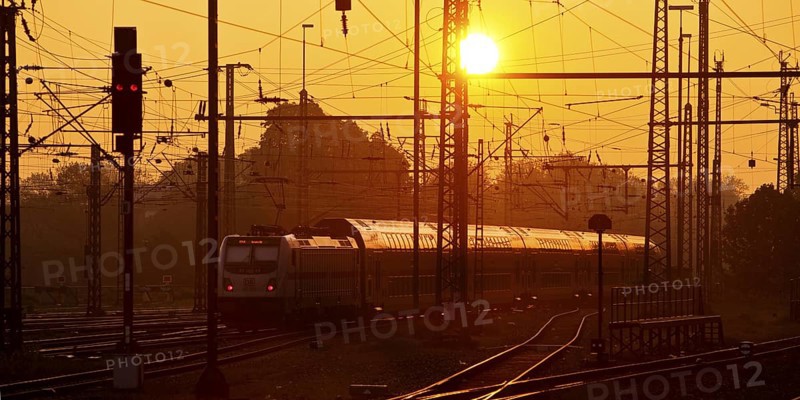 Travelling train at sunrise, Central Station, Dortmund, Ruhr Area, Germany