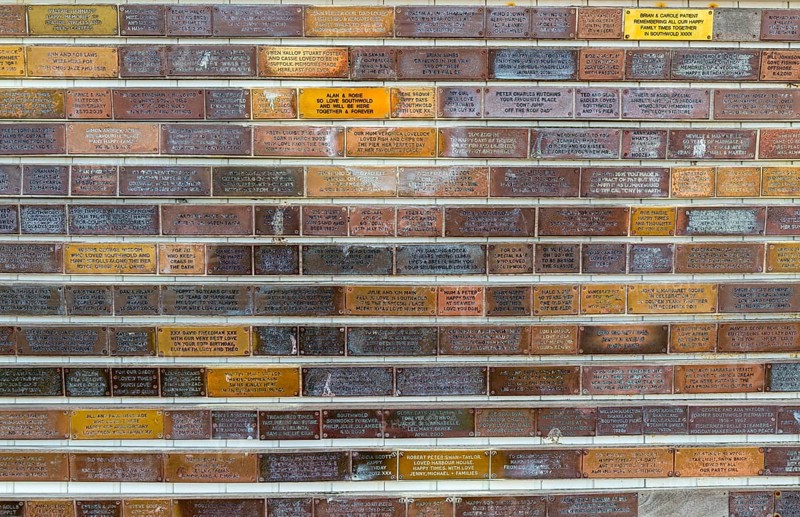Sponsorship messages on copper plaques at Southwold Pier, Southwold, Suffolk, England, UK