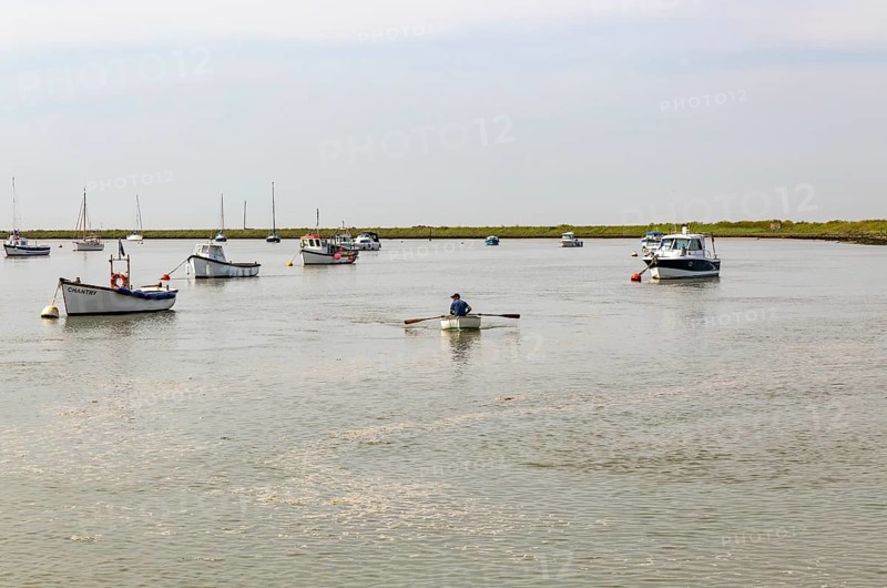 Boats at moorings on River Ore, Orford, Suffolk, England, UK
