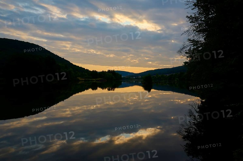 A calm river at dusk with dramatic clouds reflected in the water, summer, Grünenwört, Wertheim, Main, Main-Tauber-Kreis, Baden-Württemberg, Germany