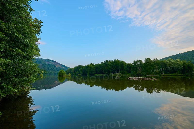 A clear blue sky with scattered clouds reflected on a quiet river, summer, Grünenwört, Wertheim, Main, Main-Tauber-Kreis, Baden-Württemberg, Germany