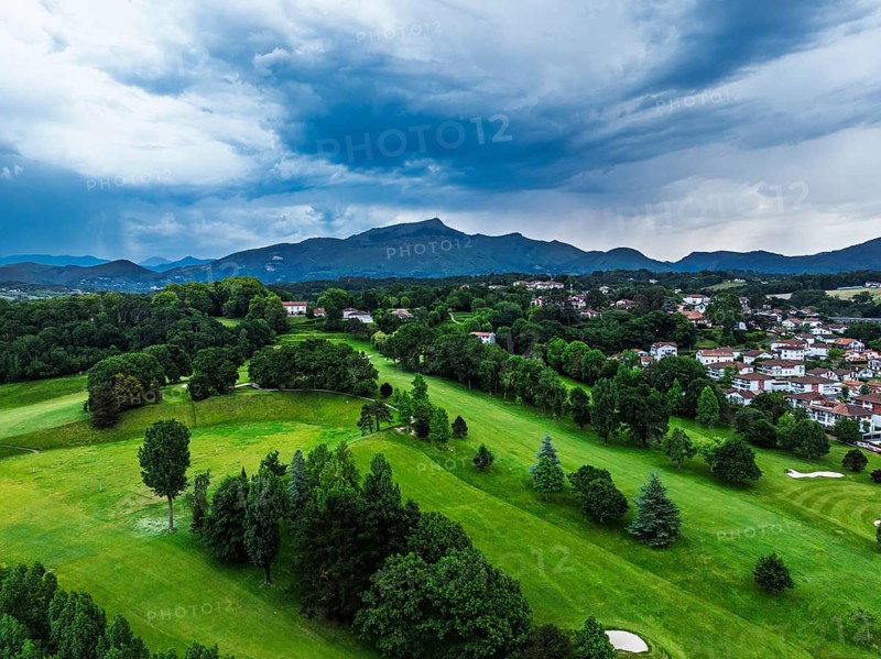 Sunset and storm clouds over Pyrenees and Saint-Jean-de-Luz from a drone, Nouvelle-Aquitaine, Pyrenees-Atlantiques, France