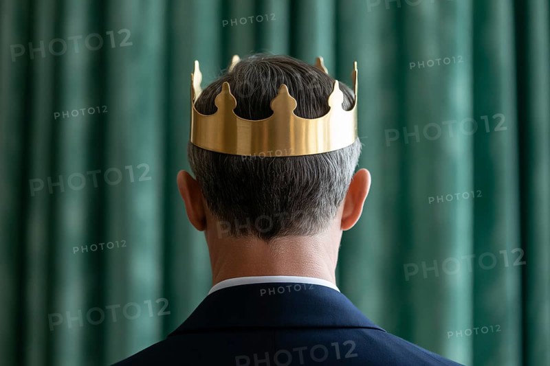 Man in suit wearing golden crown seen from behind. Formal portrait evokes themes of monarchy, power, and traditional patriarchy. Generative ai, AI generated