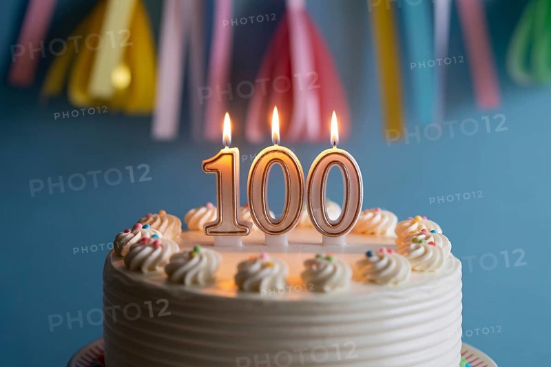 Close up of 100th birthday cake with flickering candle. Celebration of longevity and reaching a century of life. Generative ai, AI generated
