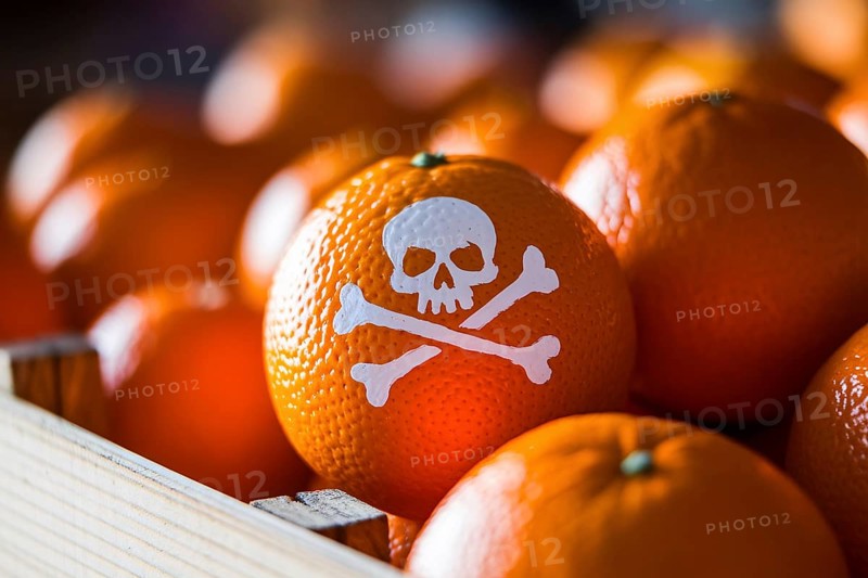 Close up of orange fruit with painted skull symbol in rustic crate, illustrating pesticide contamination and food safety concerns. Generative ai, AI generated