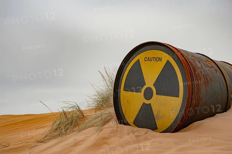 Rusty radiation barrel half-buried in sand under overcast sky. Symbol of environmental danger. Generative ai, AI generated