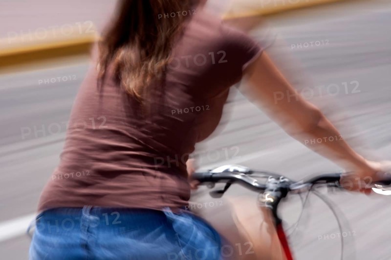 Woman riding a bicycle, Photo with motion blur, City of Quito, Pichincha province, Ecuador, South America