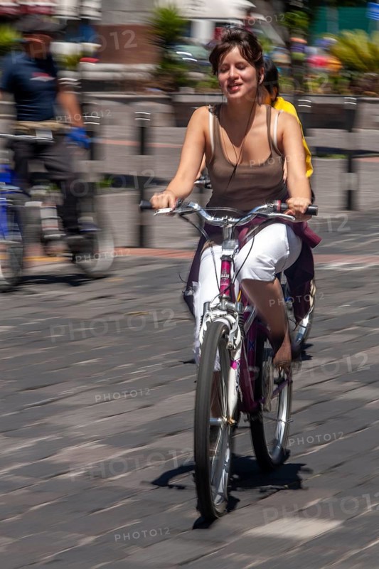 Woman riding a bicycle, Photo with motion blur, City of Quito, Pichincha province, Ecuador, South America