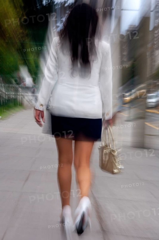 Woman walking in street, Photo with motion blur, City of Quito, Pichincha province, Ecuador, South America