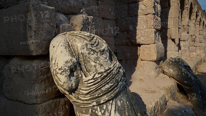 Broken ancient statue on a ruined stone wall illuminated by sunlight, ancient statue of the gods, Asklipion, Asklepieion, healing temple, temple, Hippocrates, Kos, Dodecanese, Greek Islands, Greece
