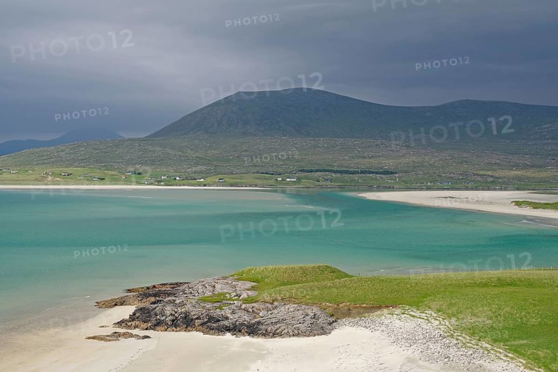 Wide sandy beach meets turquoise waters, surrounded by green hills and mountains under a gloomy sky, Seilebost Beach, Isle of Harris, Hebrides, Scotland, United Kingdom