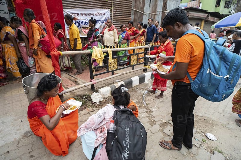Devotees eating food near a street as they arrives to visit Kamakhya Temple during Ambubachi Mela, in Guwahati, India on June 22, 2025. The Ambubachi Mela is one of the most spiritually significant and culturally unique festivals in India