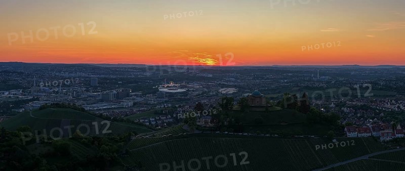 Panoramic view of a city at sunset with vineyards in the foreground and orange sky, Grabkapelle, Zum Württemberg, Rotenberg district, Stuttgart, Baden-Württemberg, Germany
