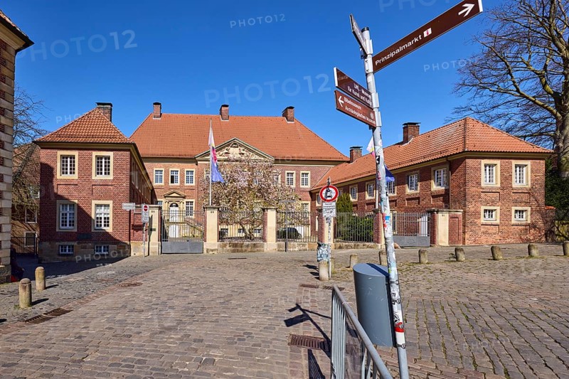 Cathedral administration, brick building, bollards, cobblestone pavement, signpost to Prinzipalmarkt, intersection Spiegelturm with Horsteberg and Domplatz, Münster, Münsterland, independent city, North Rhine-Westphalia, Germany