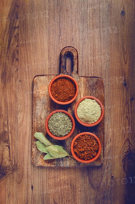 Georgian spices, in ceramic bowls, assortment, set of spices, utsho, adjika, Svan salt, ground coriander, top view, no people