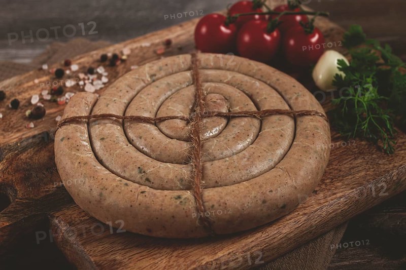 Raw spiral sausages, on a wooden board, top view, no people
