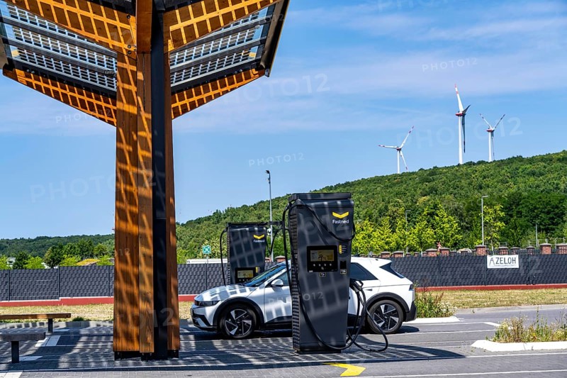 Electric charging station on the site of the former Lohberg colliery in Dinslaken, operated by Fastned, uses electricity from wind power and solar energy, fast-charging columns, with its own solar roof, wind farm on the Lohberg slagheap, North Rhine-Westphalia, Germany