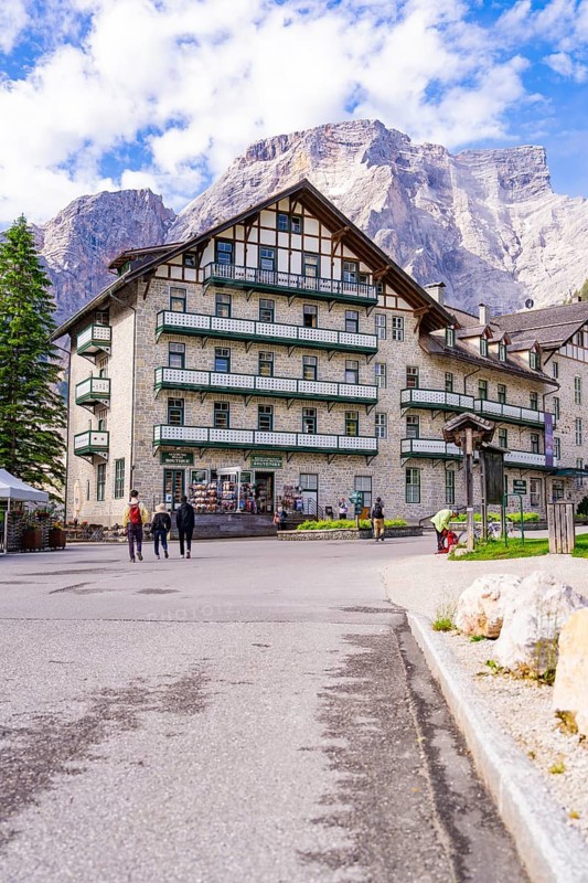 A large hotel in alpine surroundings with mountains and trees in the background, Lake Braies, South Tyrol, Dolomites, Italy