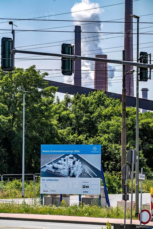 Construction site sign for thyssenkrupp Steel's first direct reduction plant, the climate-neutral steel production project, at the existing steelworks in Duisburg-Farn, pig iron production without a conventional blast furnace but using hydrogen, due to go into operation by the end of 2027, North Rhine-Westphalia, Germany