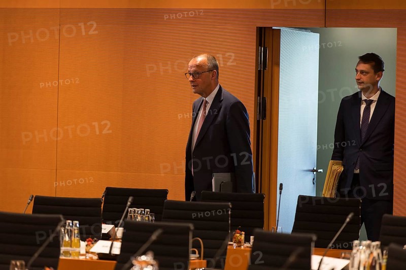 Federal Chancellor Friedrich Merz (l, CDU) arrives for the consultation between Federal Chancellor Friedrich Merz and the heads of government of the federal states in the International Conference Hall of the Federal Chancellery, Berlin, 18 June 2025