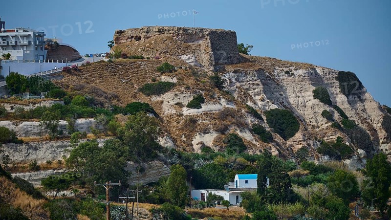 Castle, Historic ruins on an overgrown hill overlooking a rocky landscape under a blue sky, Kefalos, Kos, Dodecanese, Greek Islands, Greece