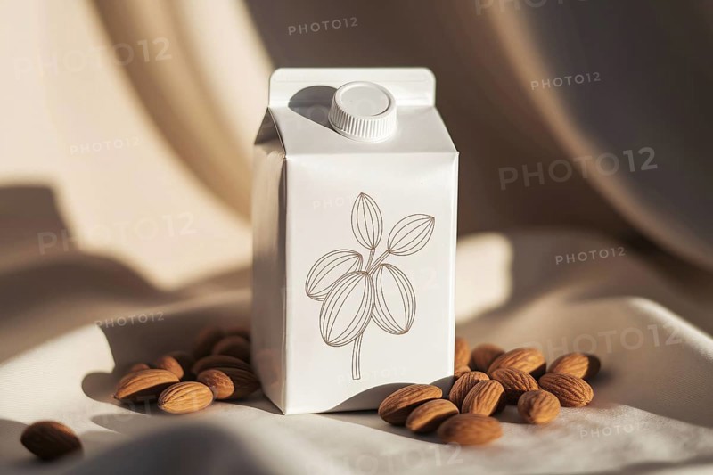 Photorealistic almond milk carton with hand-drawn almond branch illustration and no text in warm natural setting. Generative ai, AI generated
