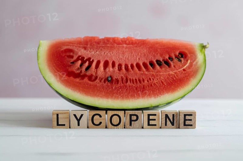 Watermelon slice with wooden blocks spelling Lycopene. Studio image emphasizing summer freshness and antioxidant content. Generative ai, AI generated