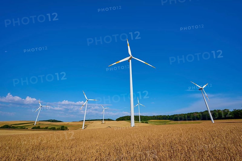 Wind turbines overlook a wide field under a clear blue sky, summer, Wenkheim, Werbach, Baden-Württemberg, Germany
