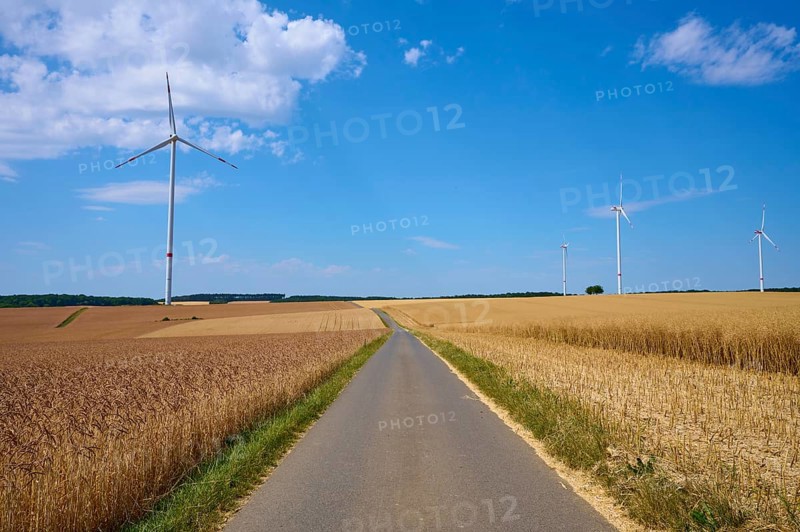 Several wind turbines above golden cornfields under a clear summer sky, summer, Retzstadt, Main Spessart district, Bavaria, Germany