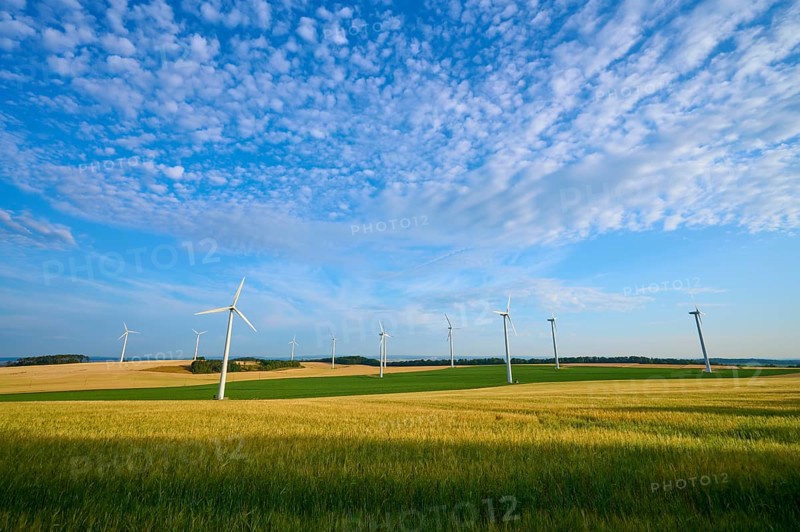 A row of wind turbines on green fields under a cloudy sky, summer, Höhefeld, Wertheim, Baden-Württemberg, Germany