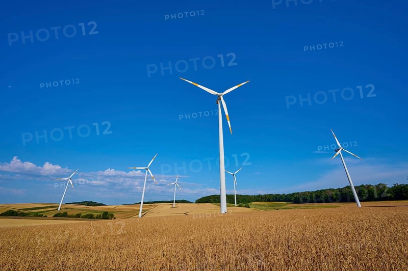 Several wind turbines standing on fields under a clear blue sky, summer, Wenkheim, Werbach, Baden-Württemberg, Germany
