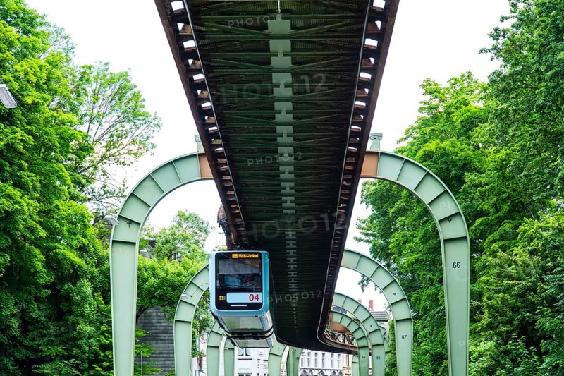 The Wuppertal suspension railway runs through Vohwinkel in front of buildings from the Wilhelminian era near the Hammerstein stop in Wuppertal, Germany
