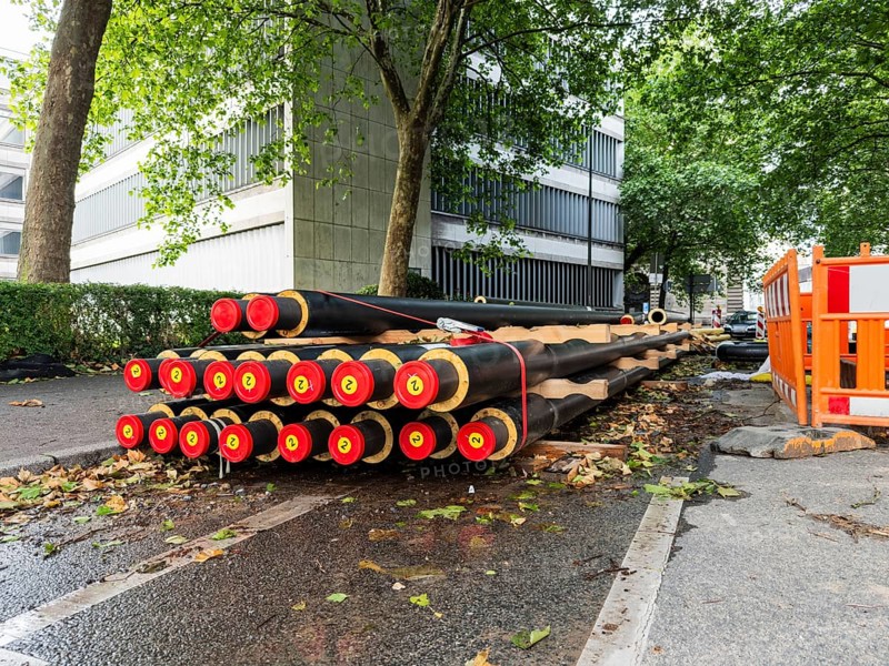 A stack of district heating pipes at a construction site in Wuppertal, Germany
